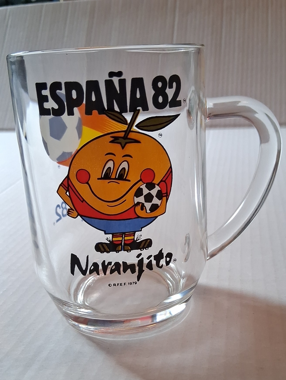 España 82 Naranjito Glass Mug - Clear with Orange Graphic